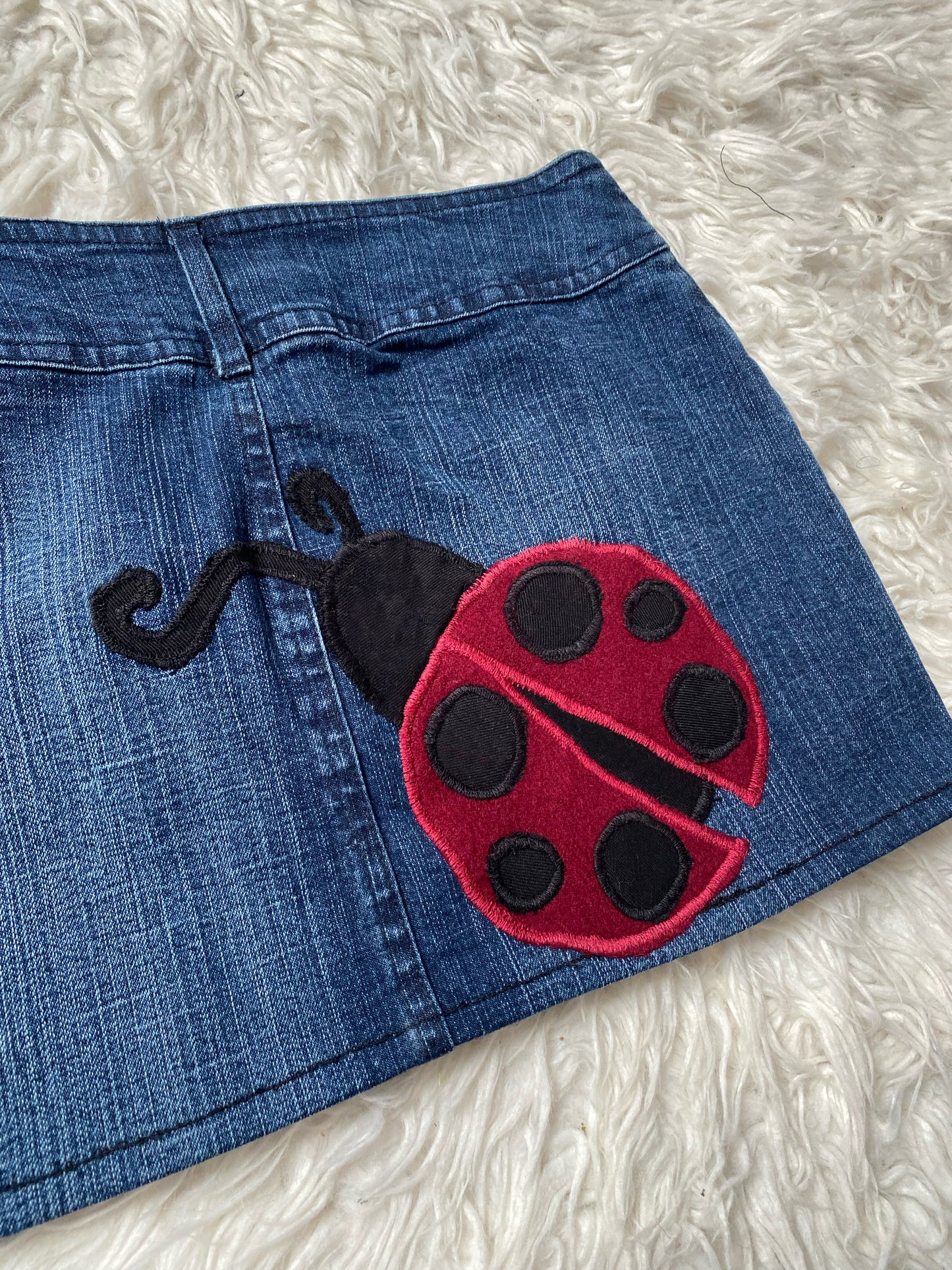 Blue denim skirt with ladybirds